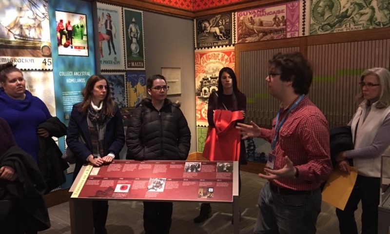 Group listening to tour guide in stamp exhibit at National Postal Museum