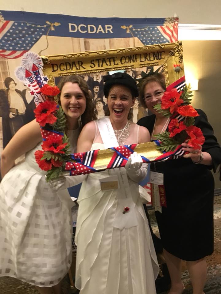 Women posed in photo frame at DCDAR State Conference