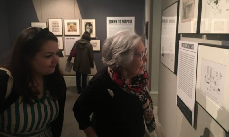 Two women looking at artwork on exhibit
