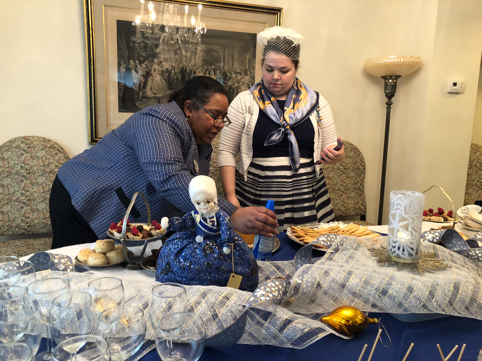 Two women preparing a table