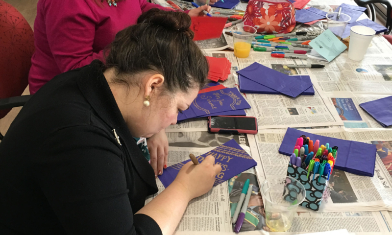 Women creating Thanksgiving Bags for vterans